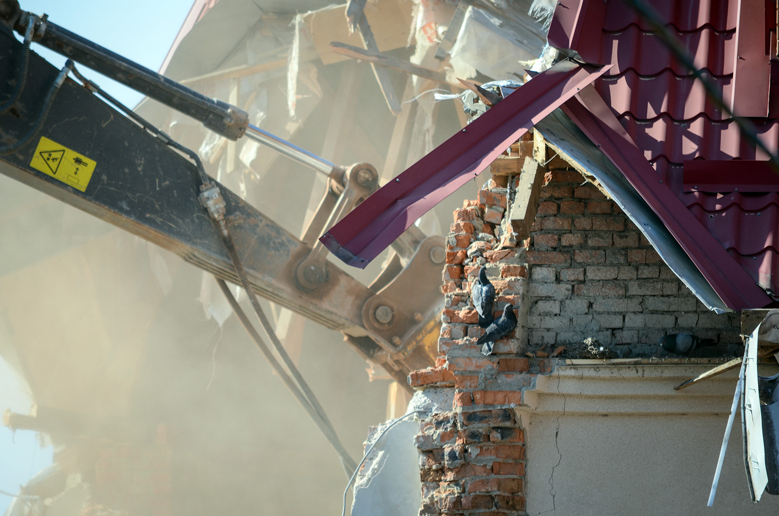 excavator demolishing a house